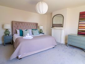 A bedroom with a bed and lamp at Pebble Cove in Lyme Regis