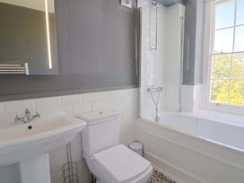 A bathroom with a sink, toilet, and bathtub at Pebble Cove in Lyme Regis