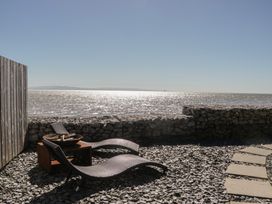 A seating area with beach chairs and a fire pit at Driftwood Cottage, Ulverston