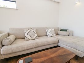 A living room with a sofa and coffee table at Driftwood Cottage in Ulverston