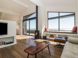 A living room with a fireplace and seating area at Driftwood Cottage in Ulverston