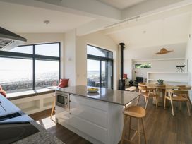 A kitchen with an island and dining area at Driftwood Cottage in Ulverston