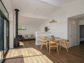 A dining room with a table and chairs at Driftwood Cottage in Ulverston