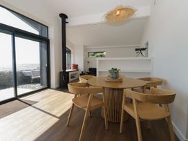 A dining room with a table and chairs at Driftwood Cottage in Ulverston
