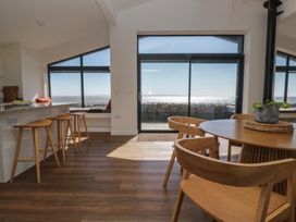A dining room with a table and chairs at Driftwood Cottage in Ulverston