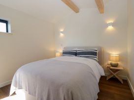 A bedroom with a bed and bedside tables at Driftwood Cottage in Ulverston