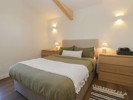 A bedroom with a bed and bedside tables at Driftwood Cottage in Ulverston