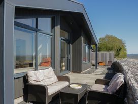An outdoor seating area with a sofa and table at Driftwood Cottage in Ulverston