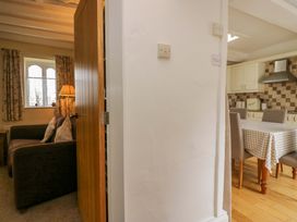 A living room with a couch and a lamp at Hollens Cottage in Grasmere