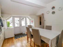 A dining room with a table and chairs at Hollens Cottage in Grasmere