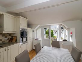 A kitchen with a table and chairs at Hollens Cottage in Grasmere