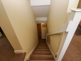 A staircase leading to a door at Hollens Cottage in Grasmere