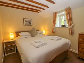 A bedroom with a double bed and nightstands at Hollens Cottage in Grasmere