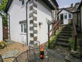 An outdoor area with a table and chairs at Hollens Cottage in Grasmere