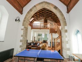 A living room with a ping pong table and seating area at Church Llygad Y Dyffryn, Sarnau near Brynhoffnant