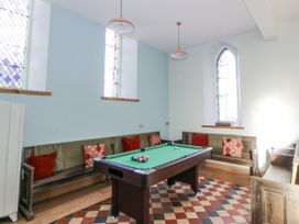 A game room with a pool table and seating at Church Llygad Y Dyffryn in Sarnau near Brynhoffnant