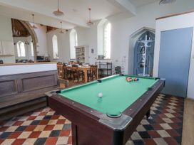 A recreation room with a pool table and dining area at Church Llygad Y Dyffryn in Sarnau near Brynhoffnant