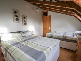 A bedroom with a double bed and a single bed at Church Llygad Y Dyffryn in Sarnau near Brynhoffnant