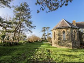 A garden with trees and a building at Church Llygad Y Dyffryn Sarnau near Brynhoffnant