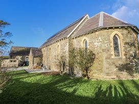 A church with a garden and trees at Church Llygad Y Dyffryn in Sarnau near Brynhoffnant