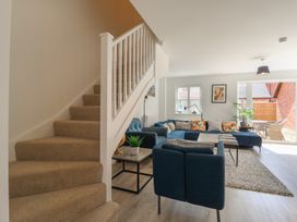 A living room with a staircase and a sofa at Inishnee House in Shotley Gate