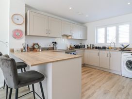 A kitchen with cabinets, sink, and appliances at Inishnee House in Shotley Gate