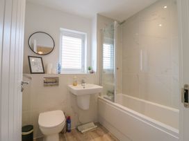 A bathroom with a sink, toilet, and bath at Inishnee House in Shotley Gate