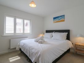 A bedroom with a bed and bedside table at Inishnee House in Shotley Gate