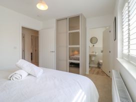 A bedroom with towels on a bed at Inishnee House in Shotley Gate