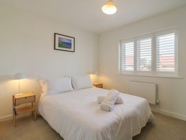 A bedroom with a bed and bedside tables at Inishnee House in Shotley Gate