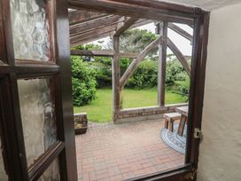 A view of a garden with a table and chairs at Horseshoe Cottage near Holywell Bay