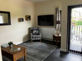 A living room with a television and an armchair at Ramson in Saltburn-By-The-Sea