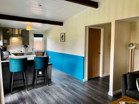 A kitchen with stools and appliances at Ramson in Saltburn-By-The-Sea