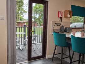 A kitchen with a door leading to the outdoor area at Ramson in Saltburn-By-The-Sea