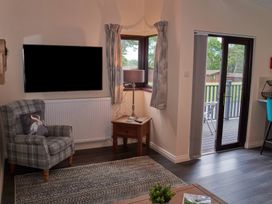 A living room with an armchair and a television at Ramson in Saltburn-By-The-Sea