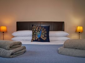 A bedroom with a bed and decorative pillow at Ramson in Saltburn-By-The-Sea