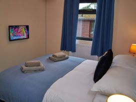 A bedroom with a bed and a television at Ramson in Saltburn-By-The-Sea