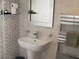 A bathroom with a sink and towel rack at Ramson in Saltburn-By-The-Sea