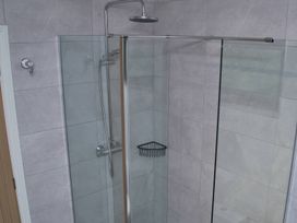 A shower with glass door and wall in Ramson at Saltburn-By-The-Sea