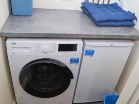 A washing machine and freezer in a laundry room at Ramson in Saltburn-By-The-Sea