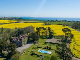 A house with a pool and garden overlooking fields and the ocean at Alston Hall in Battisborough Cross