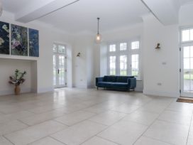 A living room with a sofa and wall art at Alston Hall Battisborough Cross