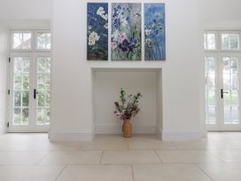 A living room with artwork and a flower arrangement at Alston Hall Battisborough Cross