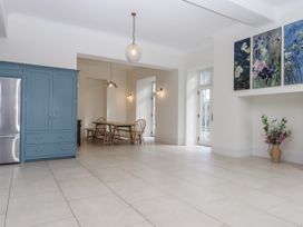A kitchen with a refrigerator and dining table at Alston Hall Battisborough Cross