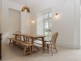 A dining room with a table and chairs at Alston Hall Battisborough Cross
