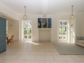 A living room with a dining table and sofa at Alston Hall near Mothecombe Beach