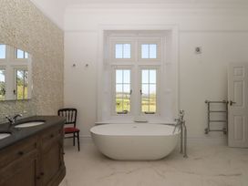 A bathroom with a bathtub and sink at Alston Hall near Mothecombe Beach