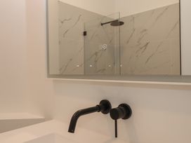 A bathroom with a shower and sink at Alston Hall near Mothecombe Beach
