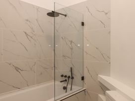 A bathroom with a bathtub and shower at Alston Hall near Mothecombe Beach