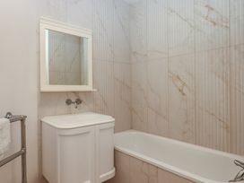 A bathroom with a sink and bath tub at Alston Hall near Mothecombe Beach